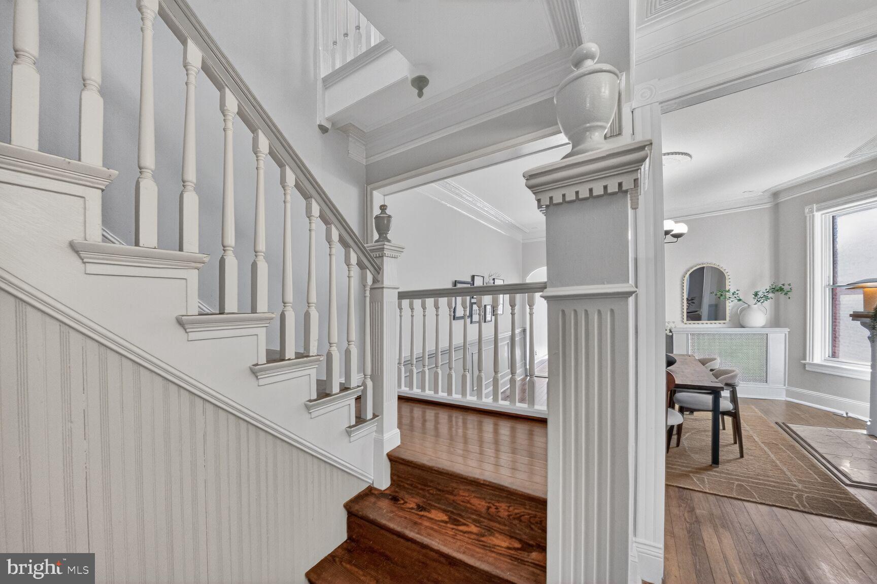 216 N Street Northwest Washington, DC 20001 - Photo 8 of 30 a view of staircase with lots of frames on wall and wooden floor