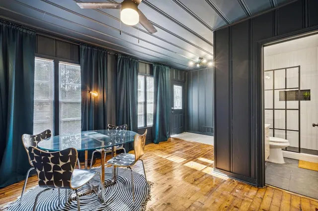 a view of a dining room with furniture and wooden floor