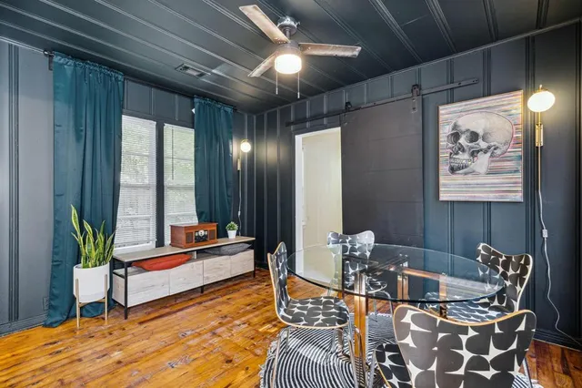 a living room with furniture and wooden floor