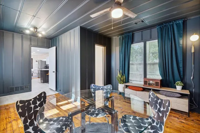 a living room with patio furniture and a large window