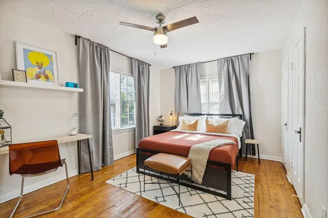 a bedroom with a bed and wooden floor