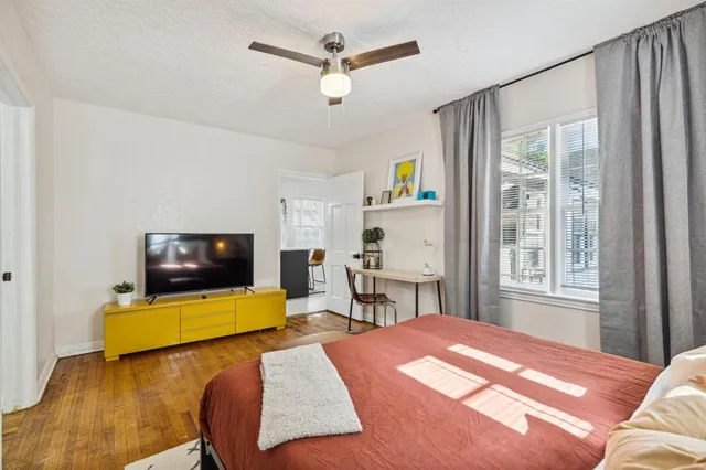 a bedroom with a bed and a flat screen tv