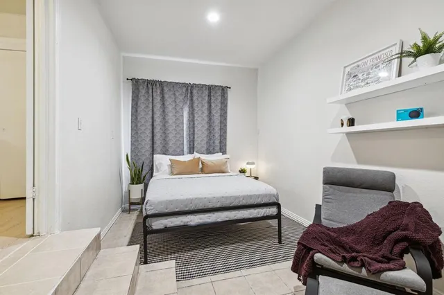 a bedroom with furniture and a window