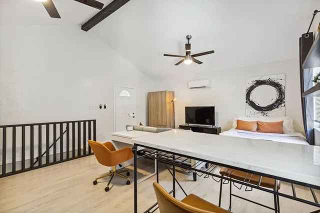 a view of a livingroom with furniture and a flat screen tv