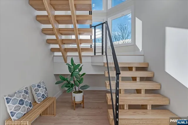 a view of entryway with wooden floor and front door
