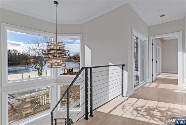a view of entryway and hall with wooden floor