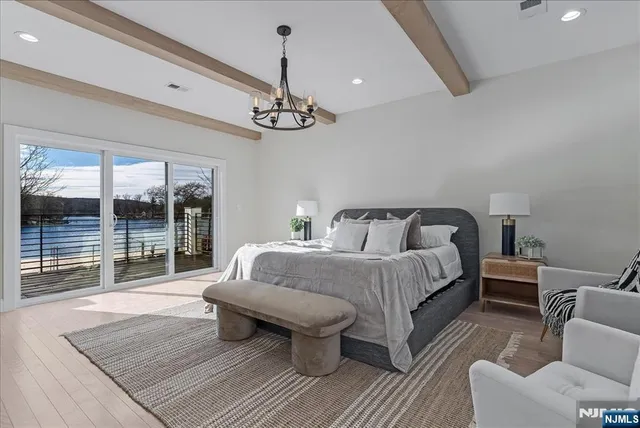 a spacious bedroom with a bed a couch and window