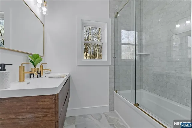 a bathroom with a sink vanity tub and a shower