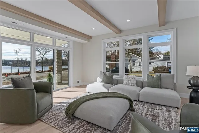 a living room with furniture and a floor to ceiling window