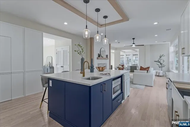 a kitchen with a sink stove and wooden floor