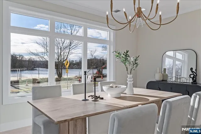 a view of a dining room with a table and chairs