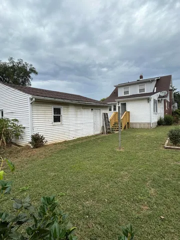 a backyard of a house with table and chairs