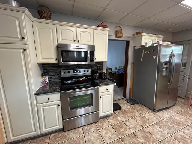 a kitchen with stainless steel appliances a refrigerator a stove a microwave and cabinets
