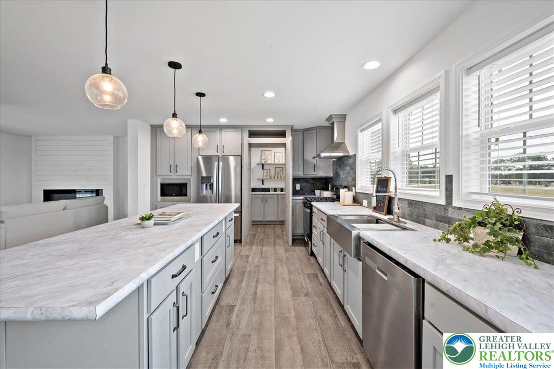 3983 Hastings Road Walnutport, PA 18088 - Photo 17 of 39 a large kitchen with kitchen island a large counter space a sink appliances and a large window