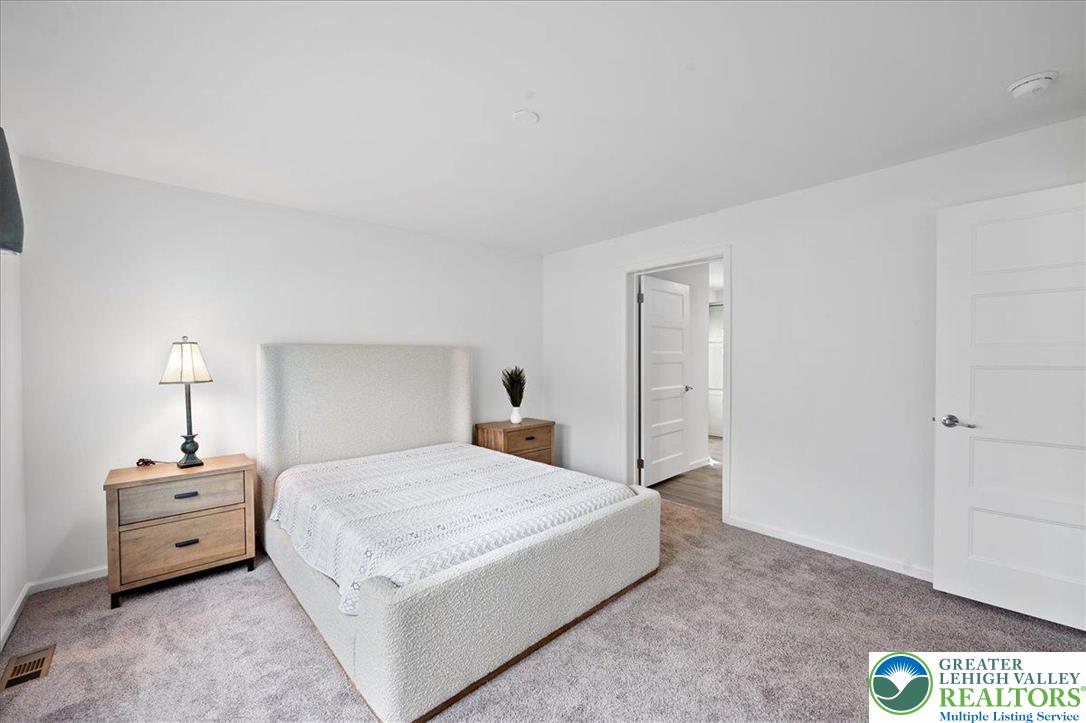 3983 Hastings Road Walnutport, PA 18088 - Photo 22 of 39 a bedroom with a bed and a lamp
