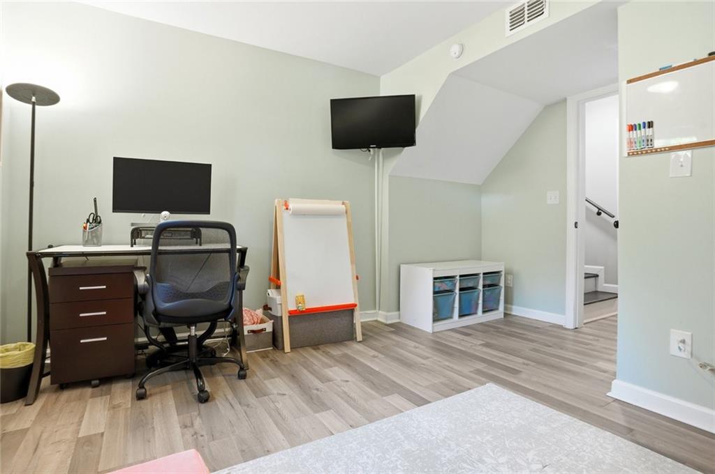 1430 Thomas Road Decatur, GA 30030 - Photo 25 of 42 a work room with furniture and a flat screen tv