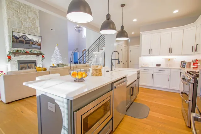 a kitchen with a sink a stove and chairs