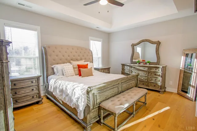 a bedroom with a bed and dresser with mirror