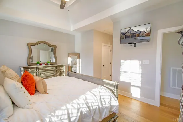 a bedroom with a bed and a painting on the wall