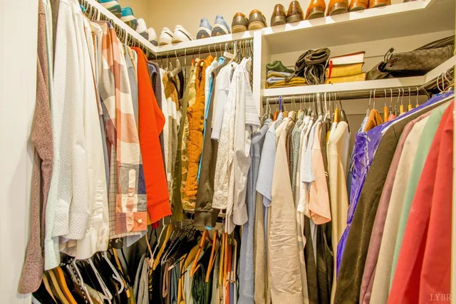 a view of walk in closet with clothes