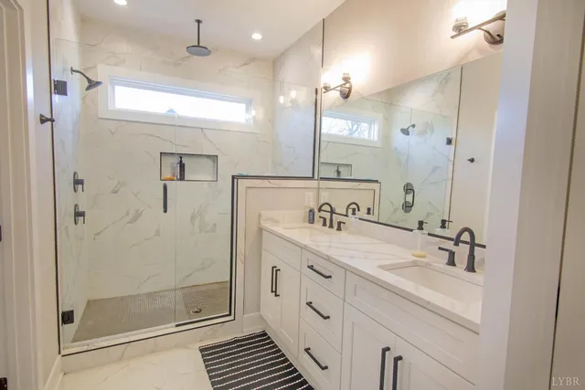 a spacious bathroom with a shower sink and mirror