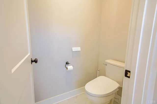a white toilet sitting in a bathroom