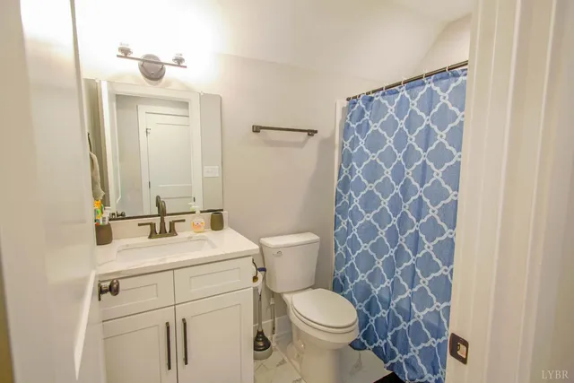 a bathroom with a sink toilet and mirror