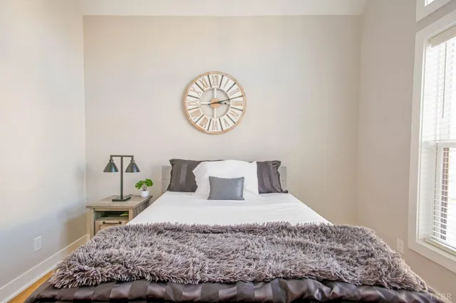 a bedroom with a bed and a window