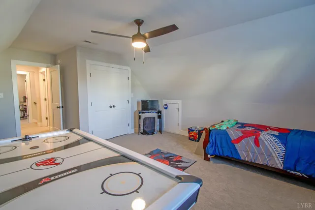 a bedroom with bed and a chandelier