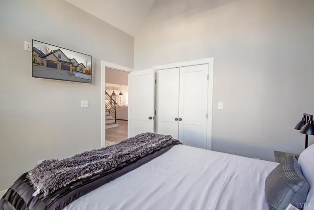 a bedroom with a bed and wall painting