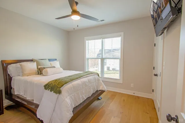 a bedroom with a bed and a window