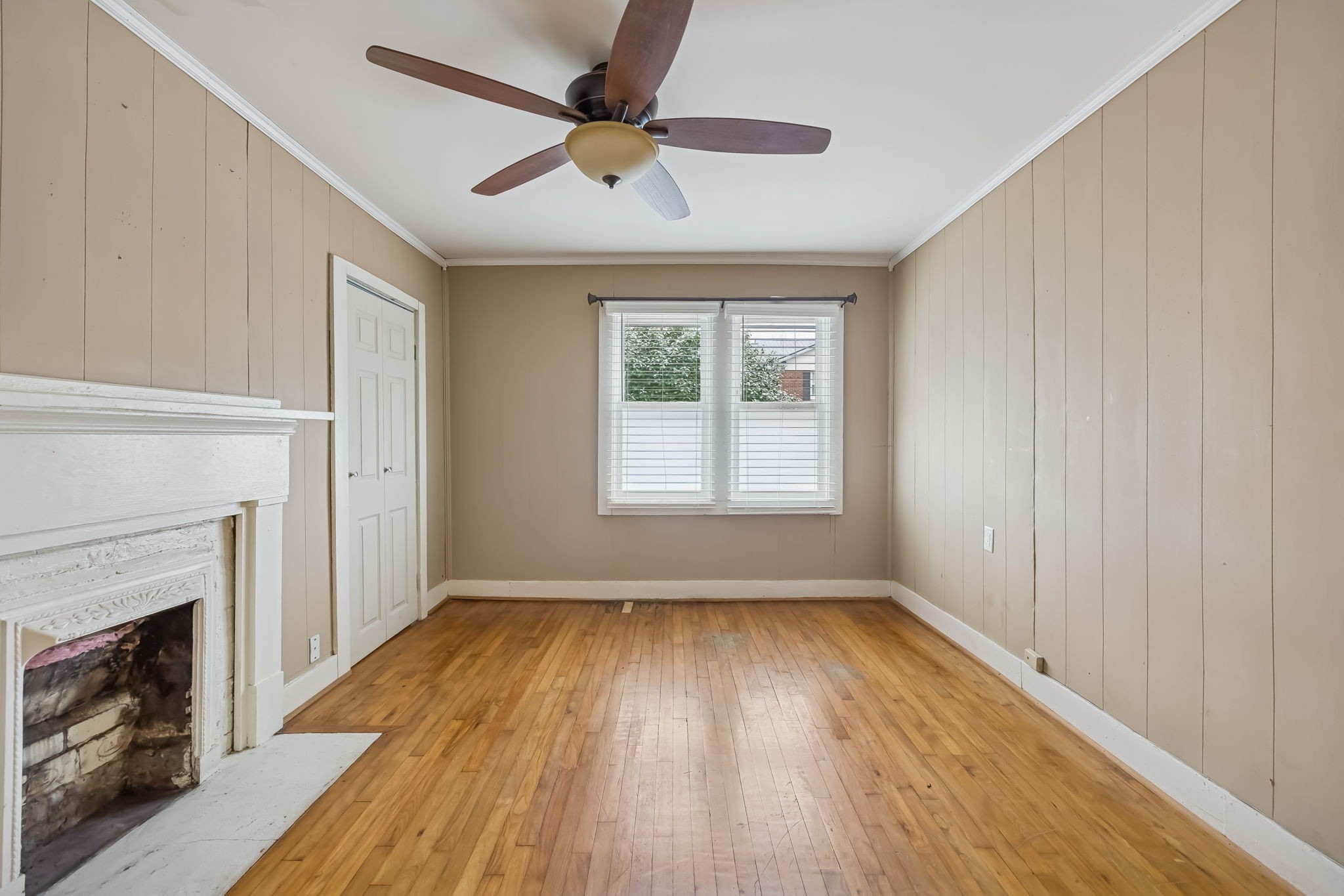 203 Hull Avenue Carthage, TN 37030 - Photo 15 of 27 a view of an empty room with wooden floor fireplace and a window