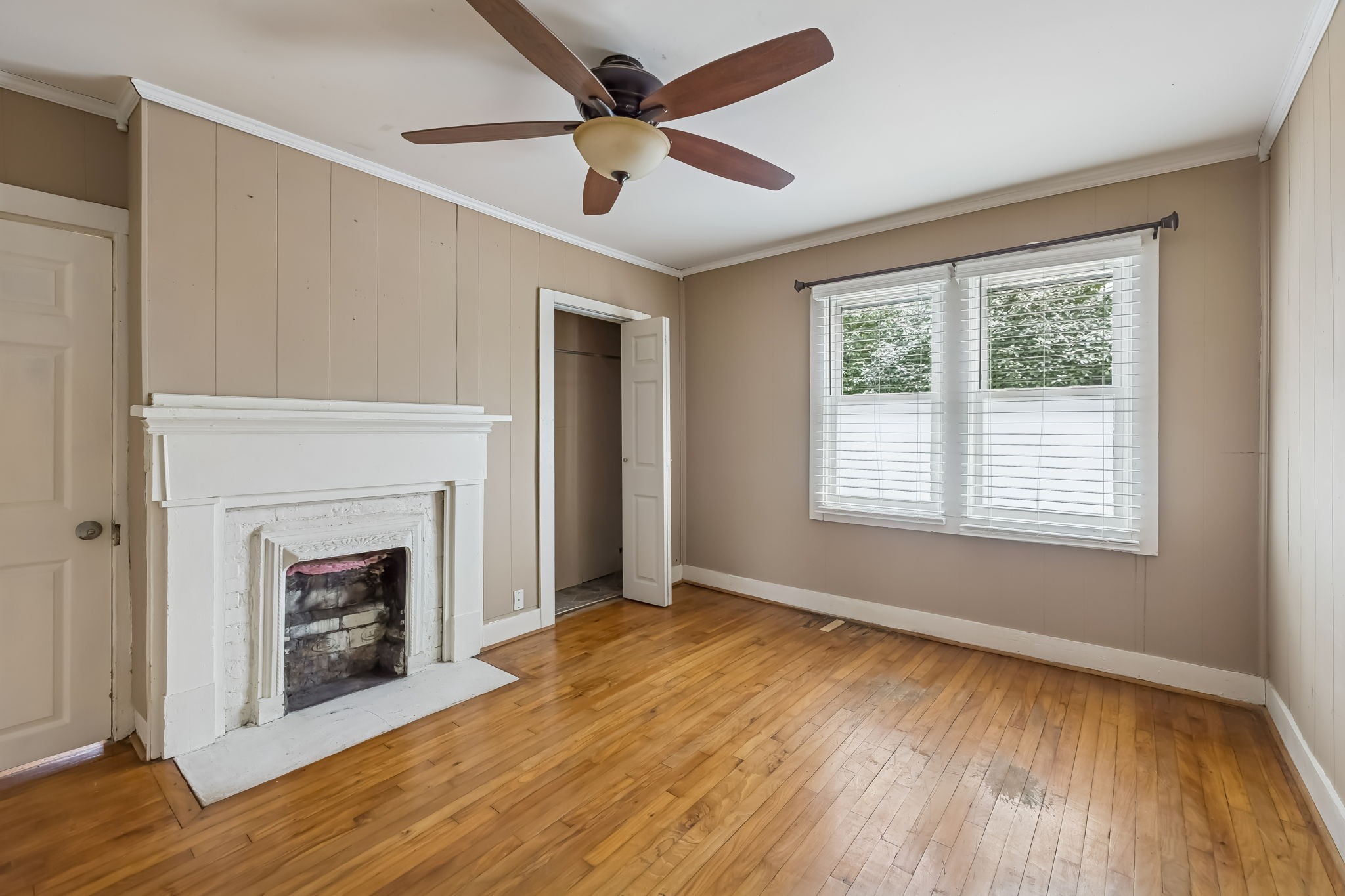 203 Hull Avenue Carthage, TN 37030 - Photo 17 of 27 a view of an empty room with wooden floor fireplace and a window