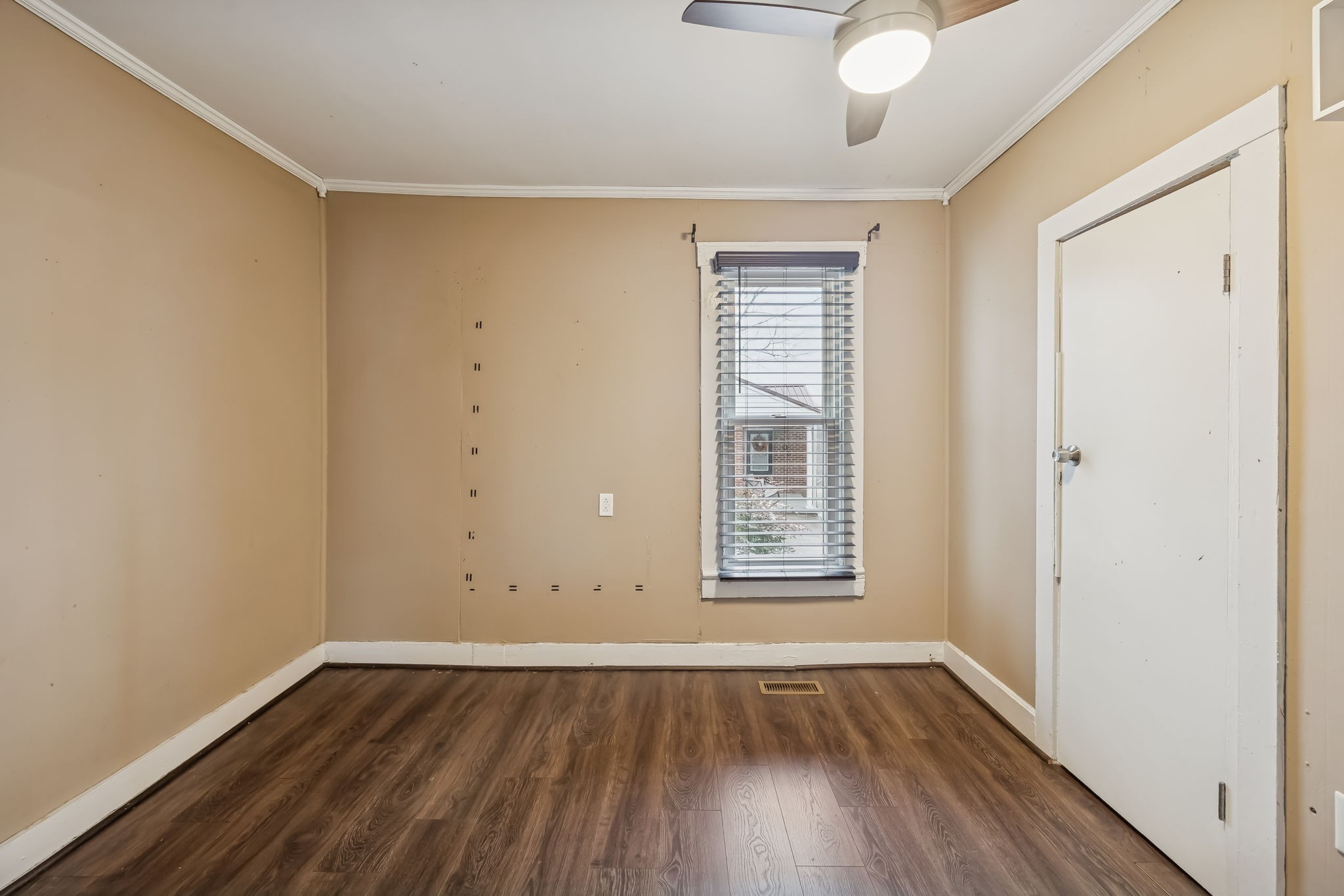 203 Hull Avenue Carthage, TN 37030 - Photo 19 of 27 an empty room with wooden floor and windows