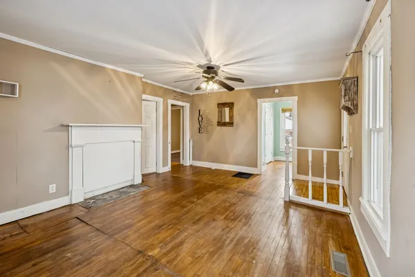wooden floor in an empty room with a window