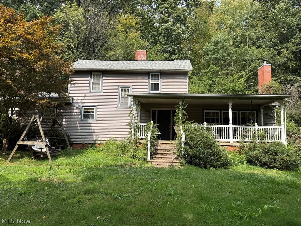 48350 Bell School Road East Liverpool, OH 43920 - Photo 1 of 1 Rear view of house with a chimney, a lawn, and covered porch