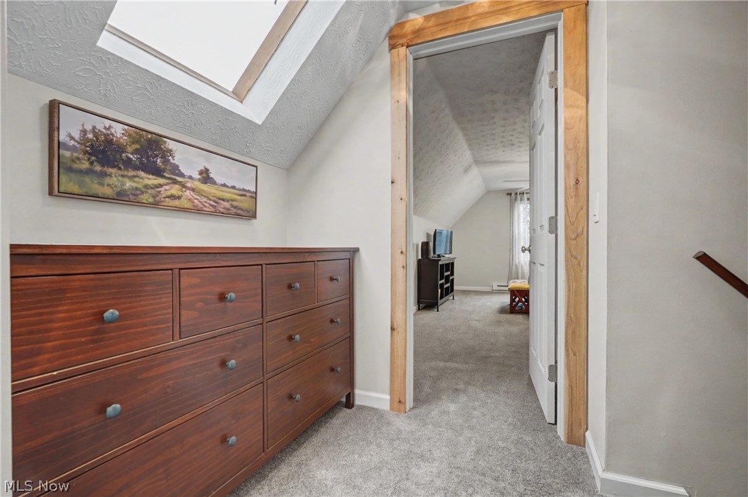 4556 Rootstown Road Ravenna, OH 44266 - Photo 26 of 50 Corridor featuring light colored carpet and a skylight