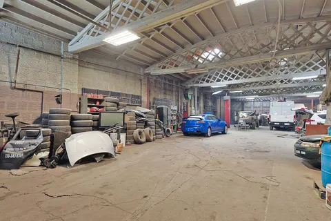 a view of parking garage with cars parked