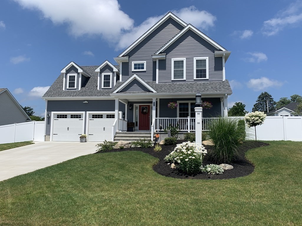 67 Fieldstone Lane, Unit 2 Fall River, MA 02720 - Photo 2 of 6 a front view of a house with a garden and yard