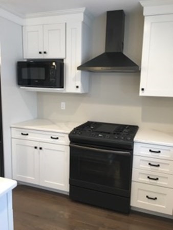 67 Fieldstone Lane, Unit 2 Fall River, MA 02720 - Photo 4 of 6 a kitchen with granite countertop white cabinets and stainless steel appliances