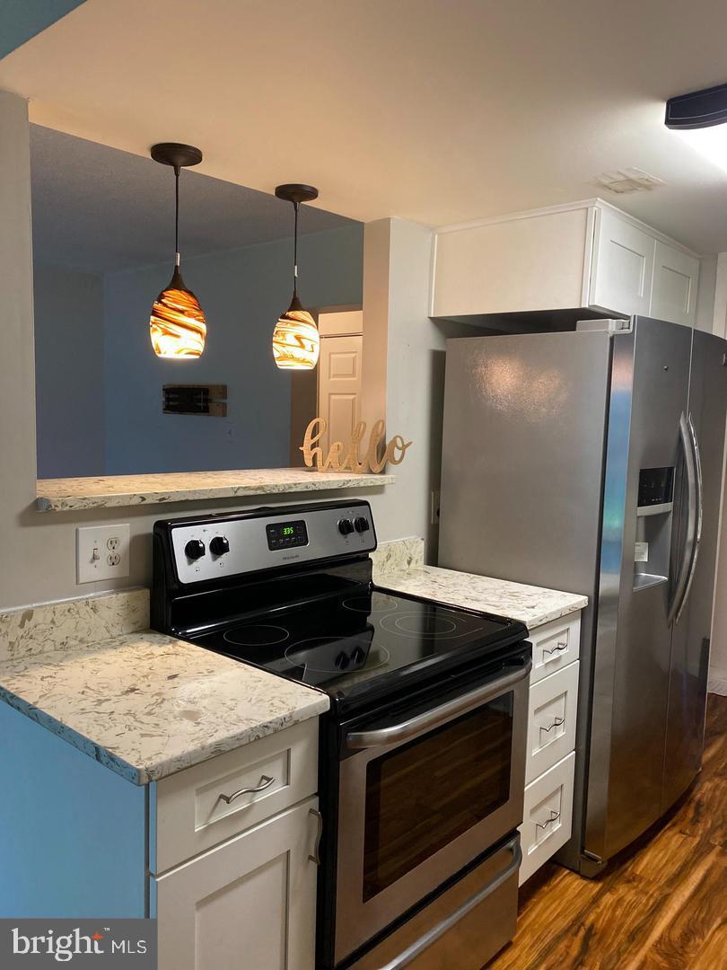 11643 Stoneview Square, Unit 2B Reston, VA 20191 - Photo 9 of 12 Modern kitchen with stylish lighting.