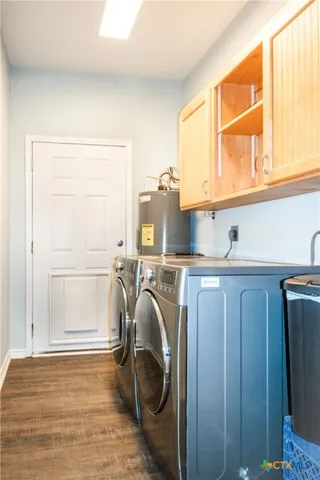 a view of an empty room with wooden floor and a ceiling fan