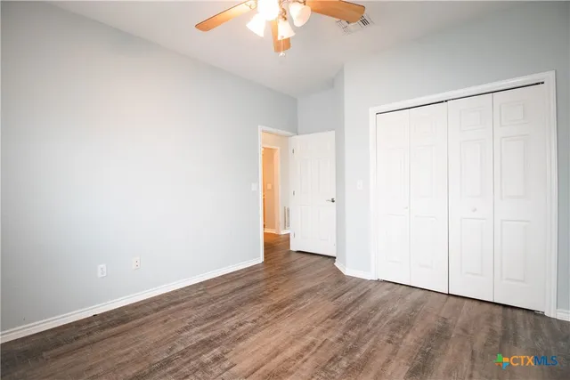 a bathroom with a toilet and a shower curtain