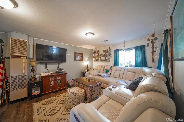 a living room with furniture and a chandelier
