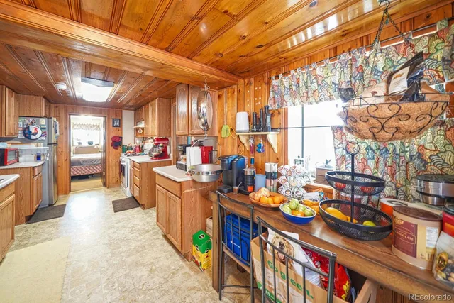a kitchen with stainless steel appliances wooden cabinets and a stove top oven