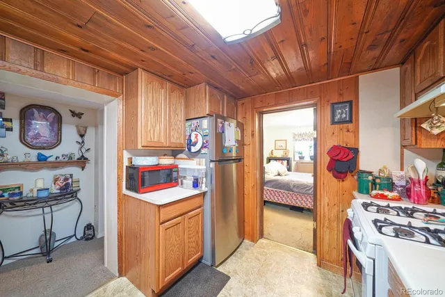 a bed sitting in a spacious bedroom next to a window