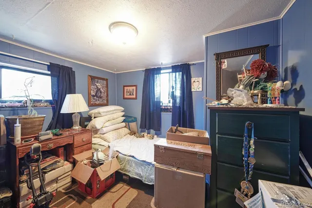 a front view of a house with a yard fountain and a tree