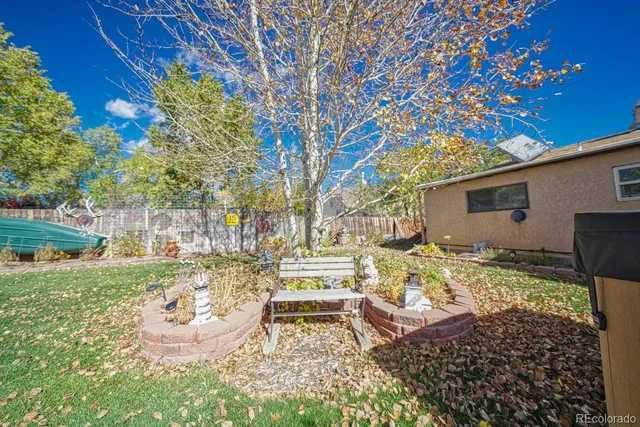 a view of a backyard with plants and outdoor seating