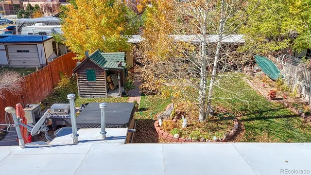a backyard of a house with table and chairs
