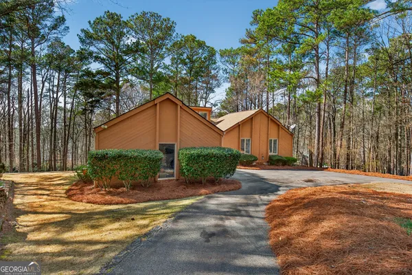 a living room with furniture a fireplace and a large window